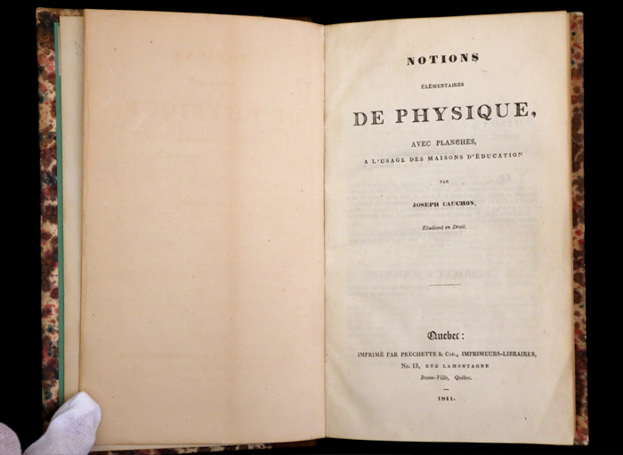 Opened book showing the text of the title page